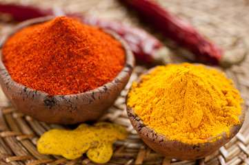 Hot red chili pepper and turmeric in clay bowls