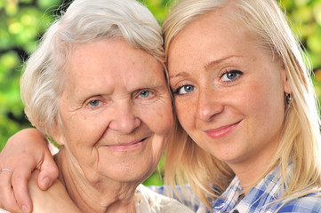 Grandmother and granddaughter. Senior and young woman outdoors.