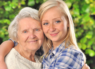 Grandmother and granddaughter. Senior and young woman outdoors.