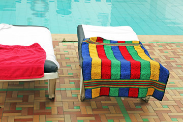 Relax chairs near the pool with towels