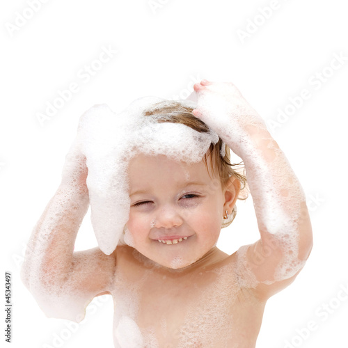 "baby girl with soap suds on hair taking bath." Stock photo and royalty