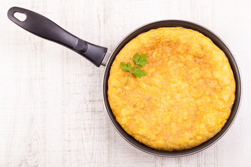 Fresh homemade Spanish tortilla (omelette) in the frying pan