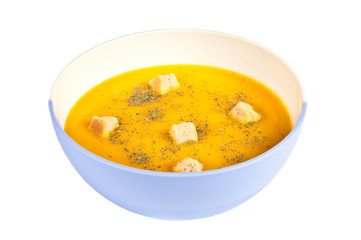 Pumpkin soup in a bowl over a white background.