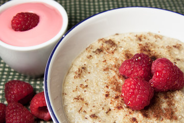 Healthy breakfast of hot oat bran cereal with yogurt and berries