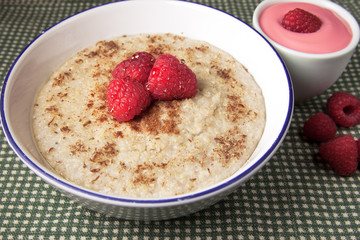 Healthy breakfast of hot oat bran cereal with yogurt and berries