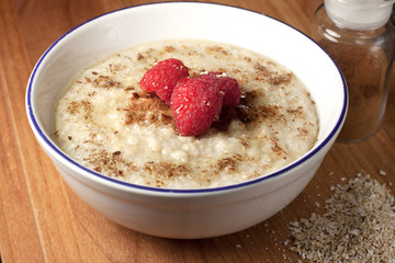 Healthy breakfast of hot oat bran cereal with yogurt and berries