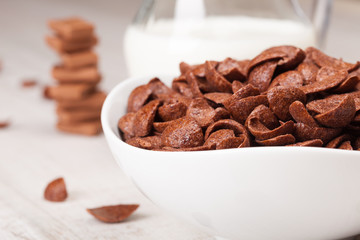 healthy breakfast with bowl of chocolate cereal and milk