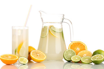 Citrus lemonade in pitcher and glass of citrus around isolated