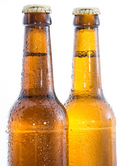 Two wet bottles of Beer on white