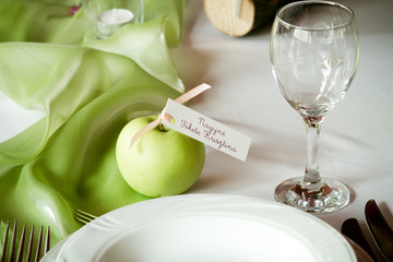 wedding tables set for fine dining, green apple