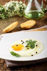Fried egg with pepper and basil