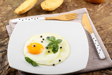 Fried egg with pepper and basil