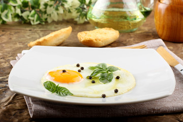 Fried egg with pepper and basil