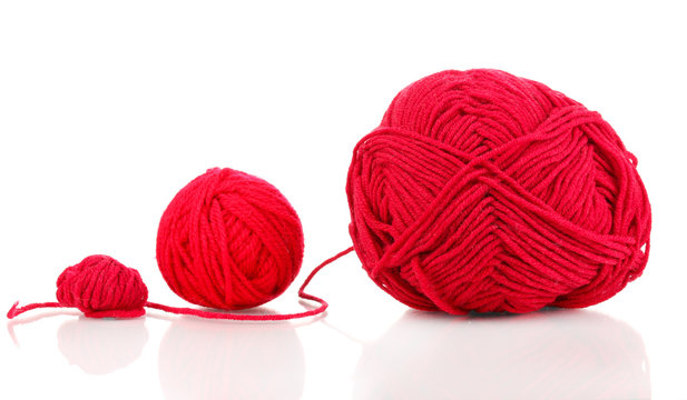 Red knittings yarns isolated on white