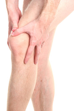 man holding sore knee, isolated on white