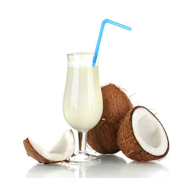 glass of coconut milk and coconuts isolated on white