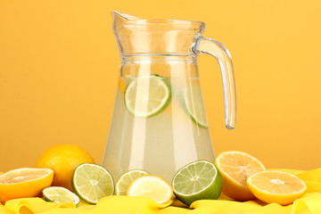 Citrus lemonade in glass pitcher of citrus around