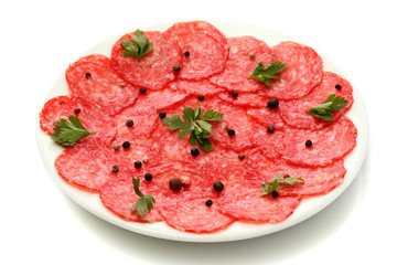 tasty sausage with spices on plate, isolated on white