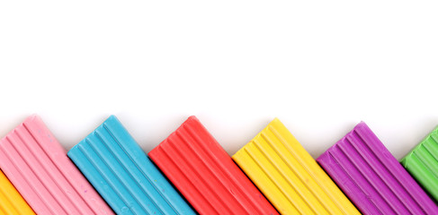 Children bright plasticine isolated on white