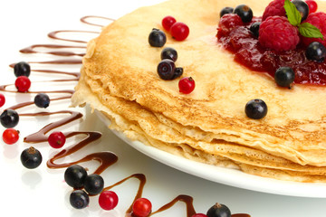 Delicious pancakes with berries and jam