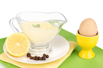 Mayonnaise in bowl on napkin isolated on white