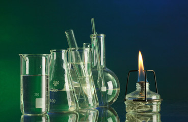 spiritlamp and test-tubes on  blue-green background