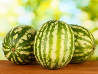Ripe watermelons on green background close-up