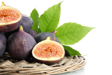 Ripe sweet figs with leaves isolated on white