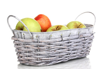 Ripe apples in basket isolated on white