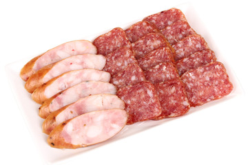 Tasty sliced sausage on plate isolated on white