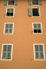 Colorful house wall with windows in mediterranean style