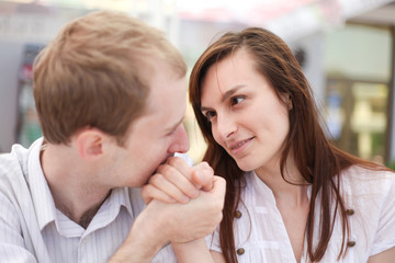 Young man kissing hand of his girlfriend on date