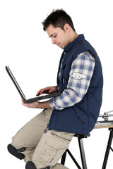 Tile couple resting on work bench with laptop