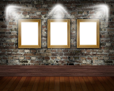 Three gold frames on brick wall in grunge room