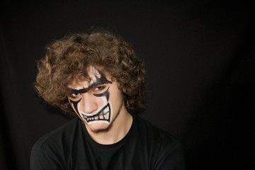 Halloween. Make-up on a face of the young man