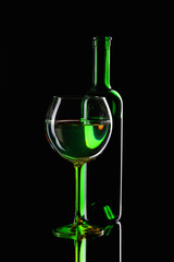 Still-life with special green wine bottles and glass