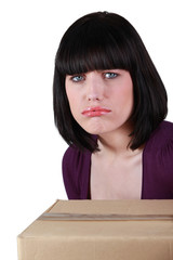 Sad brunette with box