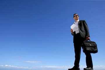 Businessman with briefcase lost in the wilderness