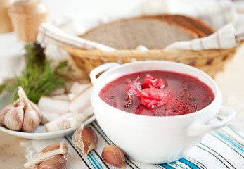 Red borscht without meat in a white bowl