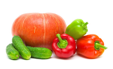 ripe pumpkin, peppers and cucumbers on a white background