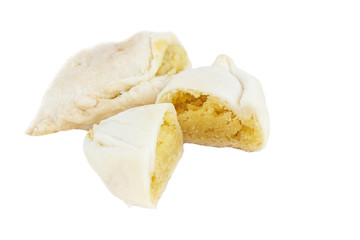 Curry puffs with potato pieces inside on white background.