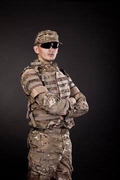 Military man on a black background