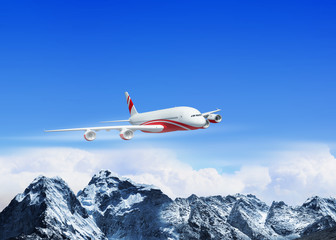 White passenger plane above the mountains