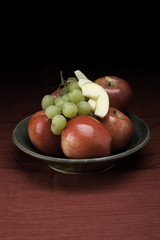 Grapes and whole and sliced apples.
