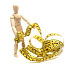 wooden doll with measuring tape