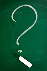 Question mark  and chalk on chalkboard