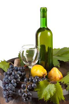 Bottle of white wine and various autumn fruits