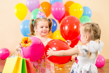 Fototapeta na wymiar pretty children with colorful balloons and gifts on birthday par