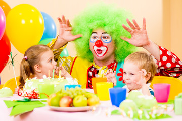 happy kids with clown on birthday party