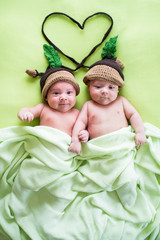 two twins brothers babies weared in acorn hats
